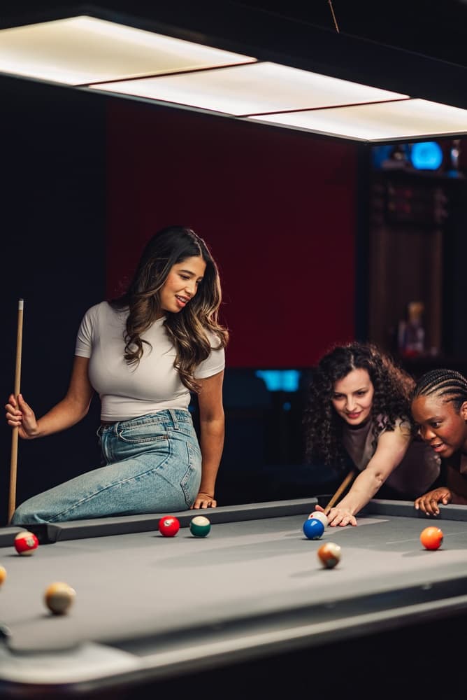 Friends playing pool together